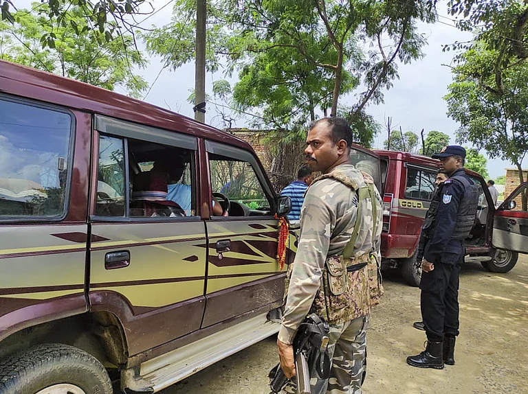 Security personnel outside the residence of a man allegedly linked to Al Qaeda, in Lohardaga district, Thursday, Aug. 22, 2024 - PTI